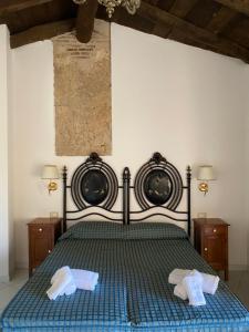 a bedroom with a bed with two towels on it at La Locanda del Curato Rooms in Lentiscosa +161 photos