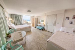 a hotel room with two beds and a table at Kuytu Bed & Breakfast in Kaş +89 photos