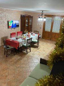 a dining room with a table and chairs and a christmas tree at Villa Angela in Lauro