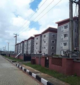a row of apartment buildings on the side of a street at Vim 2-BR-Apt With Fast Unlimited Internet & 24HRS Power in Lagos