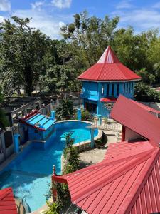 an overhead view of a swimming pool with a red roof at Heaven’s Gate Resort in Puerto Galera