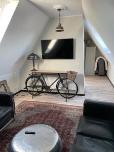 sala de estar con bicicleta y TV en WorkersHome, en Ascheberg