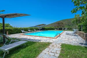 a swimming pool with chairs and an umbrella at Colle Degli Ulivi - pool, nature, relax holiday home Cortona, Italia in Cortona