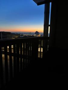 a view of the sunset from a balcony of a building at Apartament Portowy in Hel