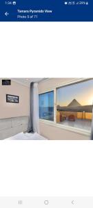a bedroom with a window with a view of a desert at Tamara Pyramids Inn in Cairo