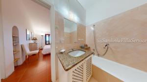 a bathroom with a sink and a shower at Appartamento Dream - Cala Granu in Porto Cervo +27 photos