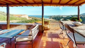 a balcony with a table and chairs and the ocean at Appartamento Dream - Cala Granu in Porto Cervo
