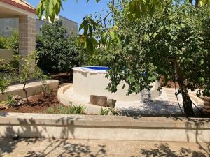 a garden with a fountain in the middle of a house at Dimora Cavalieri charming house salento puglia in Andrano
