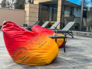 two bean bags sitting on the ground next to a table at Стоичковата къща гр. Стрелча in Strelcha