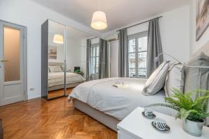 a bedroom with a bed and a large mirror at Art Around In Monti House in Milan