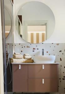 a bathroom with a sink and a mirror at La Titina Sella in Bari