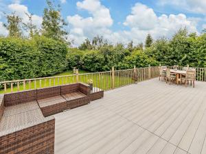 a wooden deck with a table and chairs on it at 3 Bed in York 93206 in Elvington