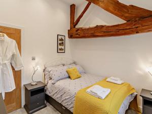 a bedroom with a bed with a yellow blanket at 3 Bed in Wintersett 93234 