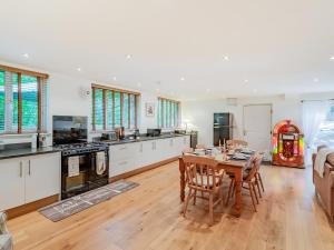 a kitchen and dining room with a table and chairs at 1 Bed in Nidderdale 93258 in Darley