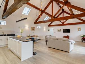 a kitchen and living room with exposed beams at 2 Bed in Wintersett 93235 