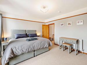 Schlafzimmer mit einem Bett, einem Tisch und einem Schreibtisch in der Unterkunft 2 Bed in Brixham 93256 in Brixham