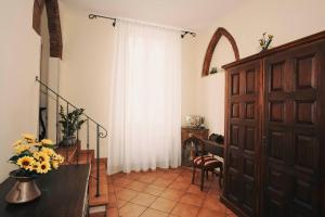 a room with a door and a vase of flowers at Hotel Galileo in Florence +42 photos