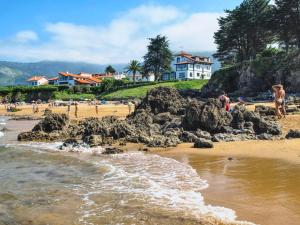 a group of people standing on a beach at Casa Bernardita in Colunga