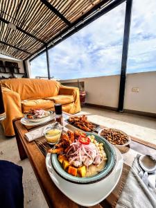 a table with a plate of food on it at Dream Place Trujillo in Trujillo