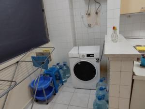a kitchen with a washing machine in a room at Lalas ASA in Praia +4 photos