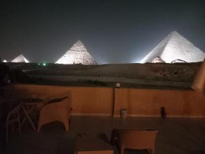 a view of the pyramids of egypt at night at Tamara Pyramids Inn in Cairo