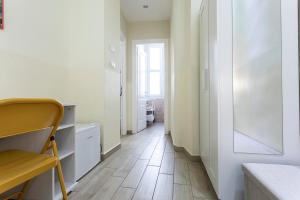 un pasillo con paredes blancas y suelo de madera en Il Guardinfante - Camera indipendente con bagno privato, en Turín