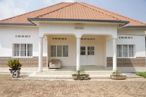 a white house with a red roof at Kigali guesthouse: shared property with individual rooms in Kigali