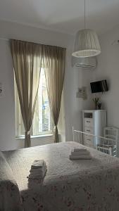 a bedroom with a large bed with towels on it at Sfumature Partenopee in Naples