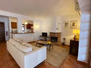 a living room with a white couch and a table at Fuengirola pueblo 2BRD townhouse in Fuengirola +25 photos