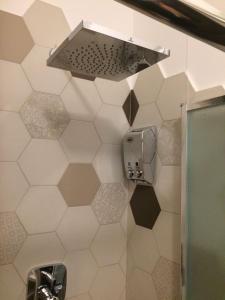 a bathroom with a shower with a shower head at Ape in Marina di Schiavonea