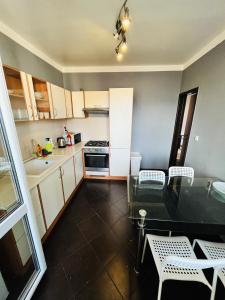 a small kitchen with a table and a dining room at Free Wifi - Harmony Hideaways in Bratislava