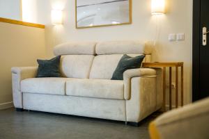 a couch with two pillows on it in a living room at Estudio Suite 408 in Alicante