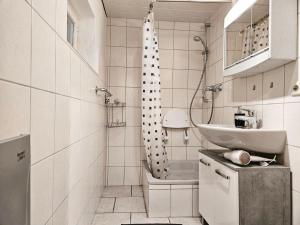 een witte badkamer met een wastafel en een douche bij Apartment in Vaihingen an der Enz - Horrheim in Vaihingen an der Enz