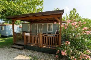 a wooden deck with a gazebo at Vacanze Glamping Boutique in San Felice del Benaco