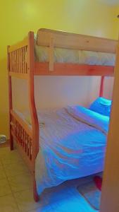 a bedroom with two bunk beds with blue sheets at great wall in Nairobi