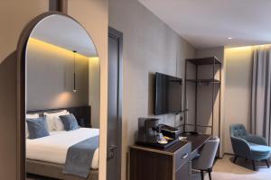 a hotel room with a bed and a mirror at Hotel Vitruvio in Milan