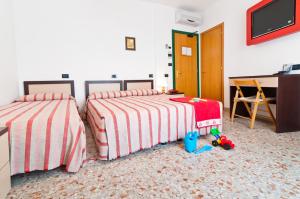 Postel nebo postele na pokoji v ubytování Hotel Milan