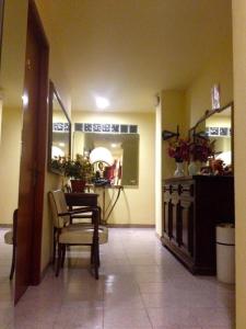 a dining room with a table and a chair in a room at HOTEL SARA in Turin +5 photos