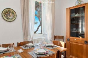 a dining room table with plates and glasses on it at Musica del Mare in Monterosso al Mare
