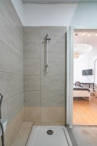 a shower with a glass door in a bathroom at Jardín Botánico Rooms in Valencia