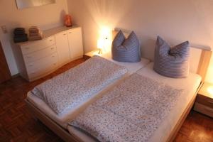 1 dormitorio con 2 camas con almohadas azules en Ferienwohnung Domes-Kreuzer, en Bad Zwesten