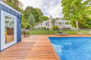 una piscina en una terraza de madera junto a una casa en East Hampton House- Heated Pool, Gym, Full Fence, en East Hampton