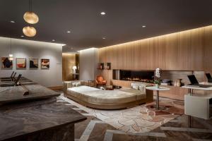 a living room with a large bed and a fireplace at Park Hyatt Toronto in Toronto