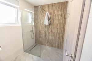 a shower with a glass door in a bathroom at House Aronija with Swimming Pool in Grude +13 photos