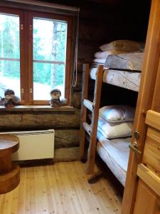 Postel nebo postele na pokoji v ubytování Kelohonkamökki ja 2 x hissilippu + 7 fotografií
