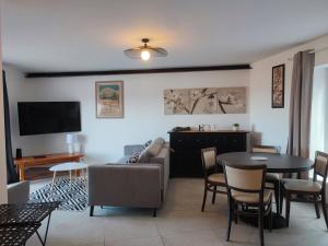 a living room with a couch and a table at BOHO 1 Vue Exceptionnelle in Bonnieux