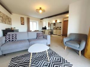 a living room with a couch and a chair at BOHO 1 Vue Exceptionnelle in Bonnieux
