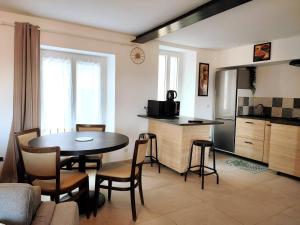 a kitchen and living room with a table and a kitchen and a dining room at BOHO 1 Vue Exceptionnelle in Bonnieux +32 photos