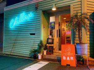 a restaurant with a bar sign in front of it at Riverside HOSTEL CHILLAX Namba in Osaka