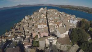 an aerial view of a village on a hill by the water at La Villa di Augusto in Anguillara Sabazia